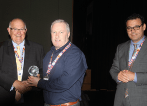 Mark Flanagan receiving a trophy for Best News Article from Geoff Want Chairman Harness Racing Australia and Andrew Kelly Chief Executive Harness Racing Australia