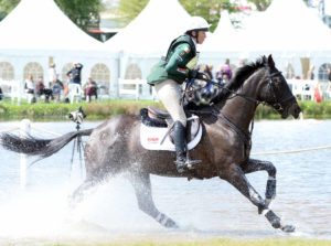 Aiofe Clark and Vaguely North gallop through the Lower Lake and lie 11th after cross country at The Mitsubishi Motors Badminton Horse Trials. Picture: Helen Revington