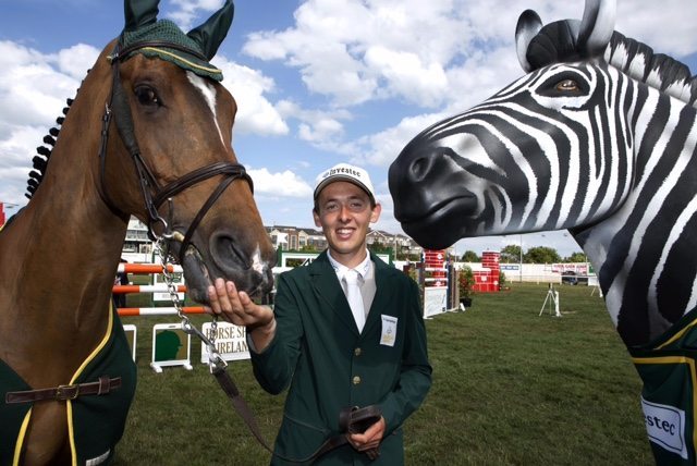 Investec and Horse Sport Ireland today announced a sponsorship partnership that will see Investec confirmed as the first ever corporate sponsor for the Irish Showjumping Team. The partnership will see Investec sponsoring Team Ireland’s involvement in the Dublin Horse Show and FEI European Championships at Aachen, Germany – a key stage for Horse Sport Ireland as Ireland’s showjumpers focus their individual and collective efforts on qualifying for the Rio Olympics in 2016. Ireland now has nine riders placed in the world top 100 with Bertram Allen at number five. Allen was on hand along with Captain Michael Kelly and Greg Broderick for the announcement along with Investec’s own iconic equine brand ambassador – its well-known Zebra ‘Nairobi’. Pictured is Bertram Allen. Picture by Shane O'Neill / Copyright Fennell Photography 2015.