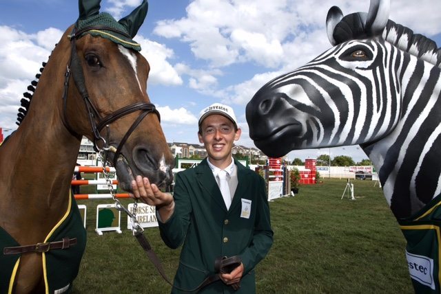 Investec and Horse Sport Ireland today announced a sponsorship partnership that will see Investec confirmed as the first ever corporate sponsor for the Irish Showjumping Team. The partnership will see Investec sponsoring Team Ireland’s involvement in the Dublin Horse Show and FEI European Championships at Aachen, Germany – a key stage for Horse Sport Ireland as Ireland’s showjumpers focus their individual and collective efforts on qualifying for the Rio Olympics in 2016. Ireland now has nine riders placed in the world top 100 with Bertram Allen at number five. Allen was on hand along with Captain Michael Kelly and Greg Broderick for the announcement along with Investec’s own iconic equine brand ambassador – its well-known Zebra ‘Nairobi’. Pictured is Bertram Allen. Picture by Shane O'Neill / Copyright Fennell Photography 2015.