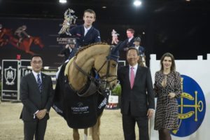 Bertram Allen on Quiet Easy 4 receives the winner's trophy from the hands of Mr. Michael Lee (left) and Dr Simom S O IP (right) at the end of Hong Kong Jockey Club Trophy during the Longines Masters of Hong Kong on 19 February 2016 at the Asia World Expo in Hong Kong, China. Photo by Juan Manuel Serrano / Power Sport Images