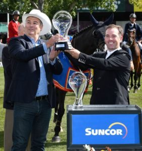 Cian O’Connor raises the winning trophy with Steve Reynish, Executive Vice President, Strategy & Corporate Development, Suncor Energy.